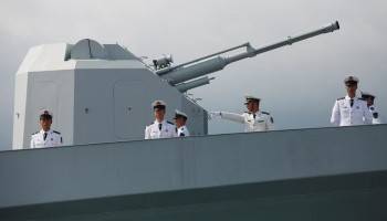 Chinese navy servicemen stand at the rea